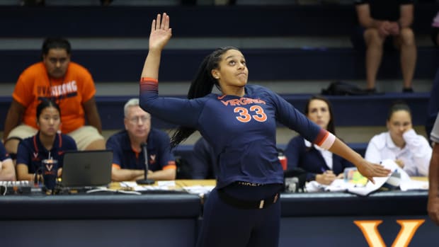 Lauryn Bowie swings at a ball during the Virginia volleyball match against Wofford at Memorial Gymnasium.